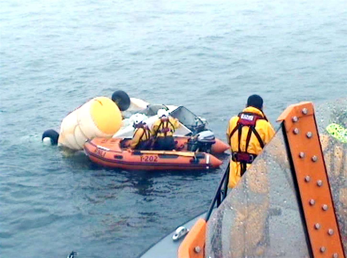 RNLI volunteers and Coastguard inspecting the wreckage of the Super Puma L2 helicopter (RNLI/PA)