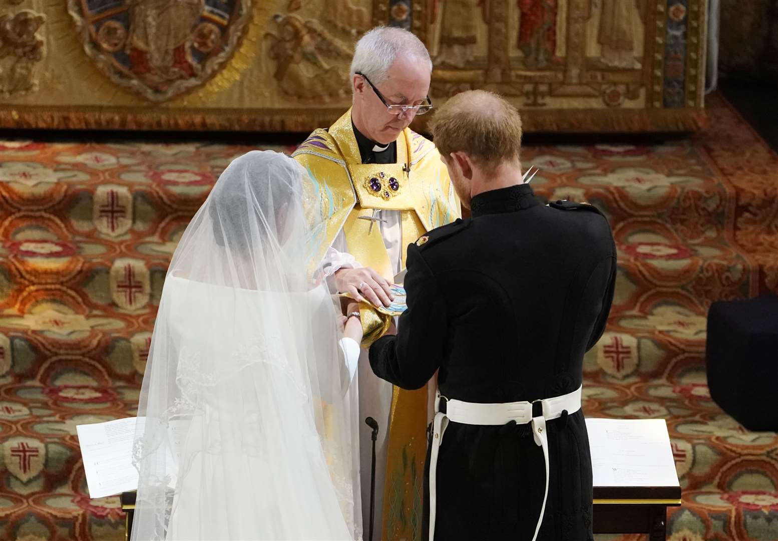 Archbishop of Canterbury Justin Welby joins the hands of Harry and Meghan (Owen Humphreys/PA)