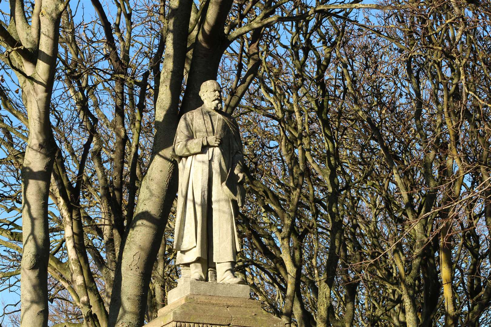 The statue of Dr John Alexander above Wick's riverside.