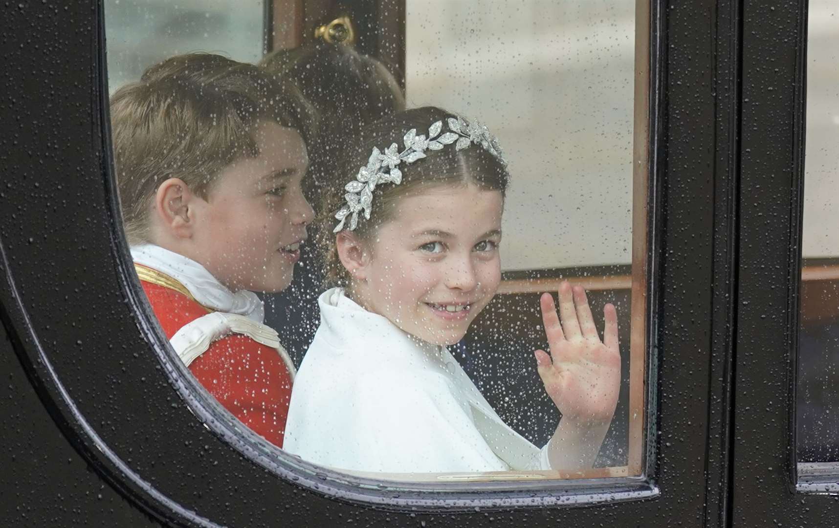 Princess Charlotte and Prince George return to Buckingham Palace by coach after the coronation (Joe Giddens/PA)