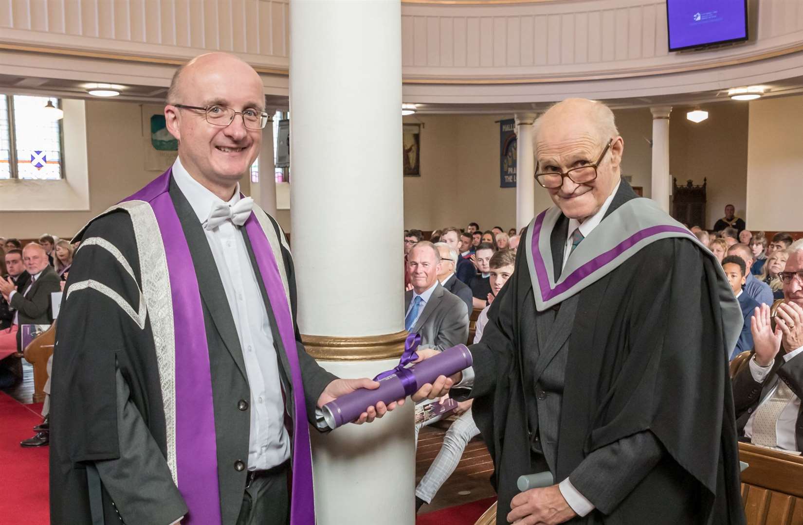 Professor Neil Simco, vice principal, research and impact, University of the Highlands and Islands, presents John Macdonald with his honorary fellowship. Picture: Duncan McLachlan