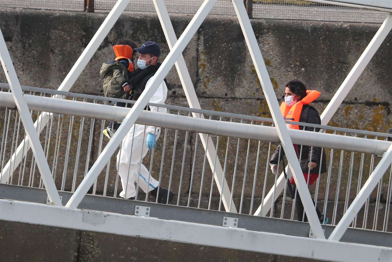 A group of people, including a child, thought to be migrants are brought into Dover, Kent (Gareth Fuller/PA)