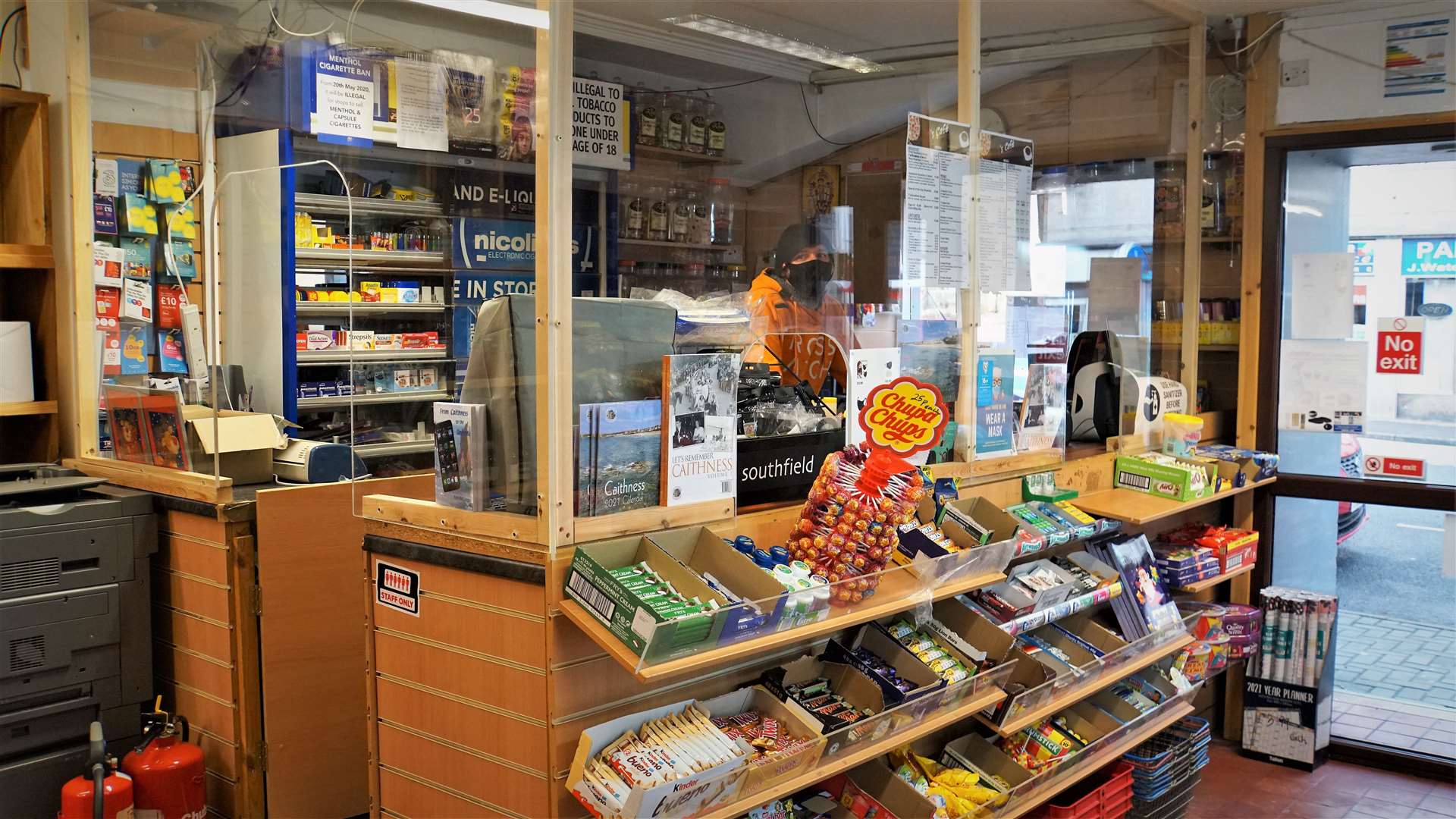 Popular staff member Jarvis manning the counter of the Jim Bews newsagent shop below T's café.