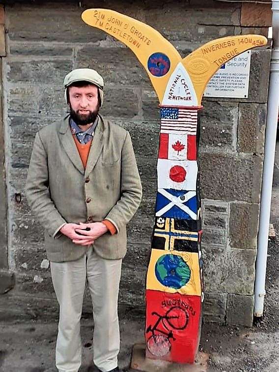 Alexander Glasgow beside the recently painted totem at Thurso railway station.