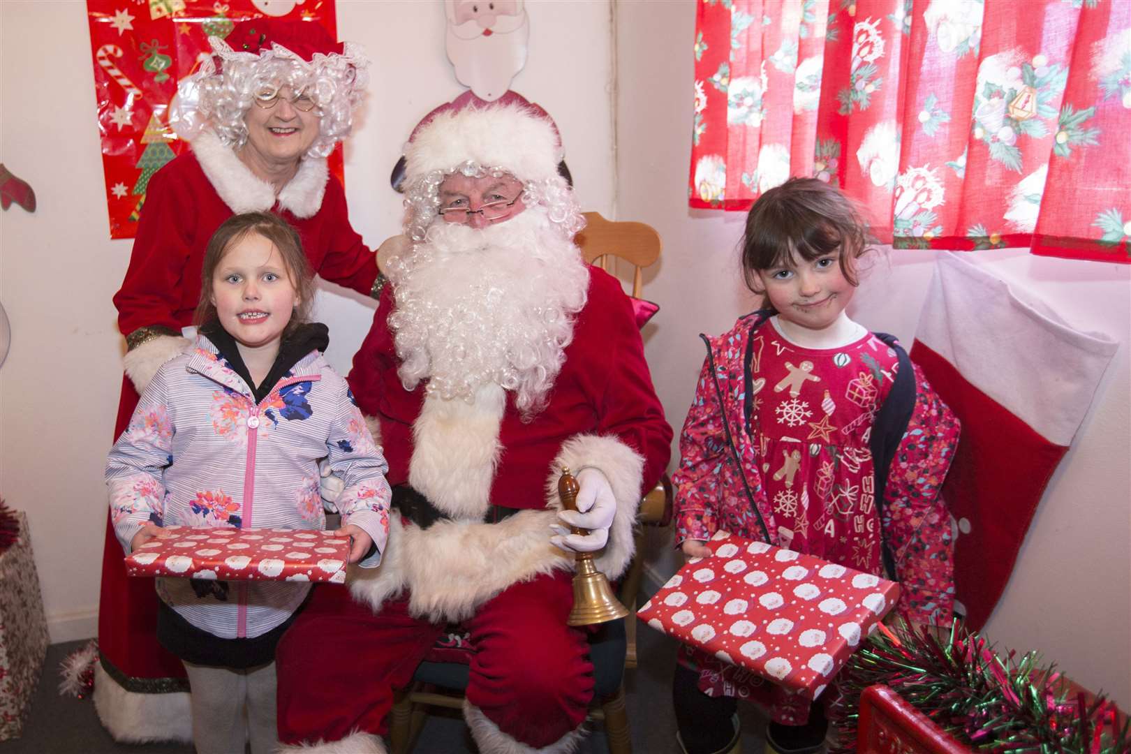 Five-year-olds Rhiannon Gilmore-Sutherland (left) and Lauren Newlands, both from Bettyhill, meeting Santa and Mrs Claus in their grotto during Wick Fun Day. Picture: Robert MacDonald / Northern Studios