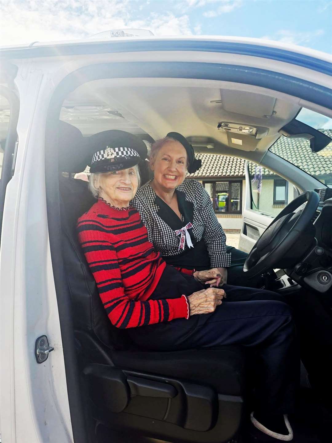 Gwen Stewart and Jeanine have a go at the sirens in the police van.
