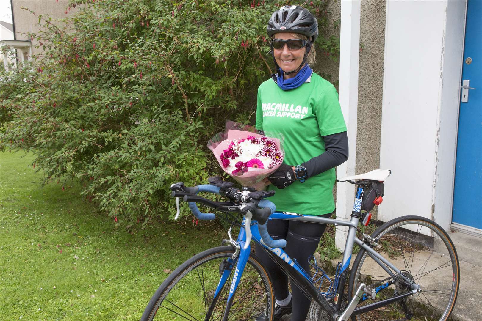 Home at 7.24am on Saturday, after just over five days on the road and having completed 755 miles, Lorna poses for a photo with a bunch of flowers received from her sister along with the Macmillan Cancer supporters' T-shirt. Picture: Robert MacDonald / Northern Studios