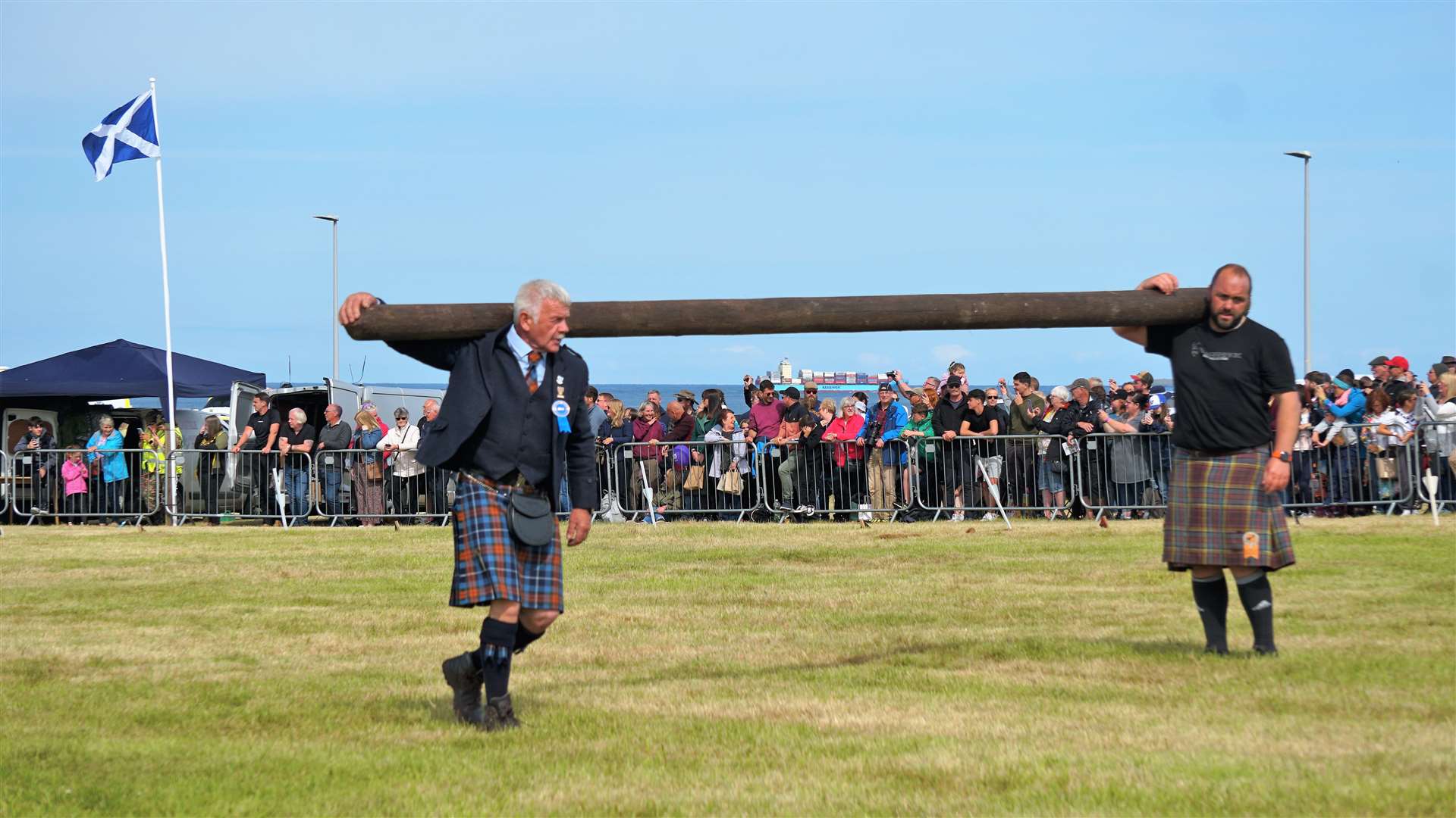 Charlie Murray helps remove a caber from the field with Stuart Anderson. Picture: DGS