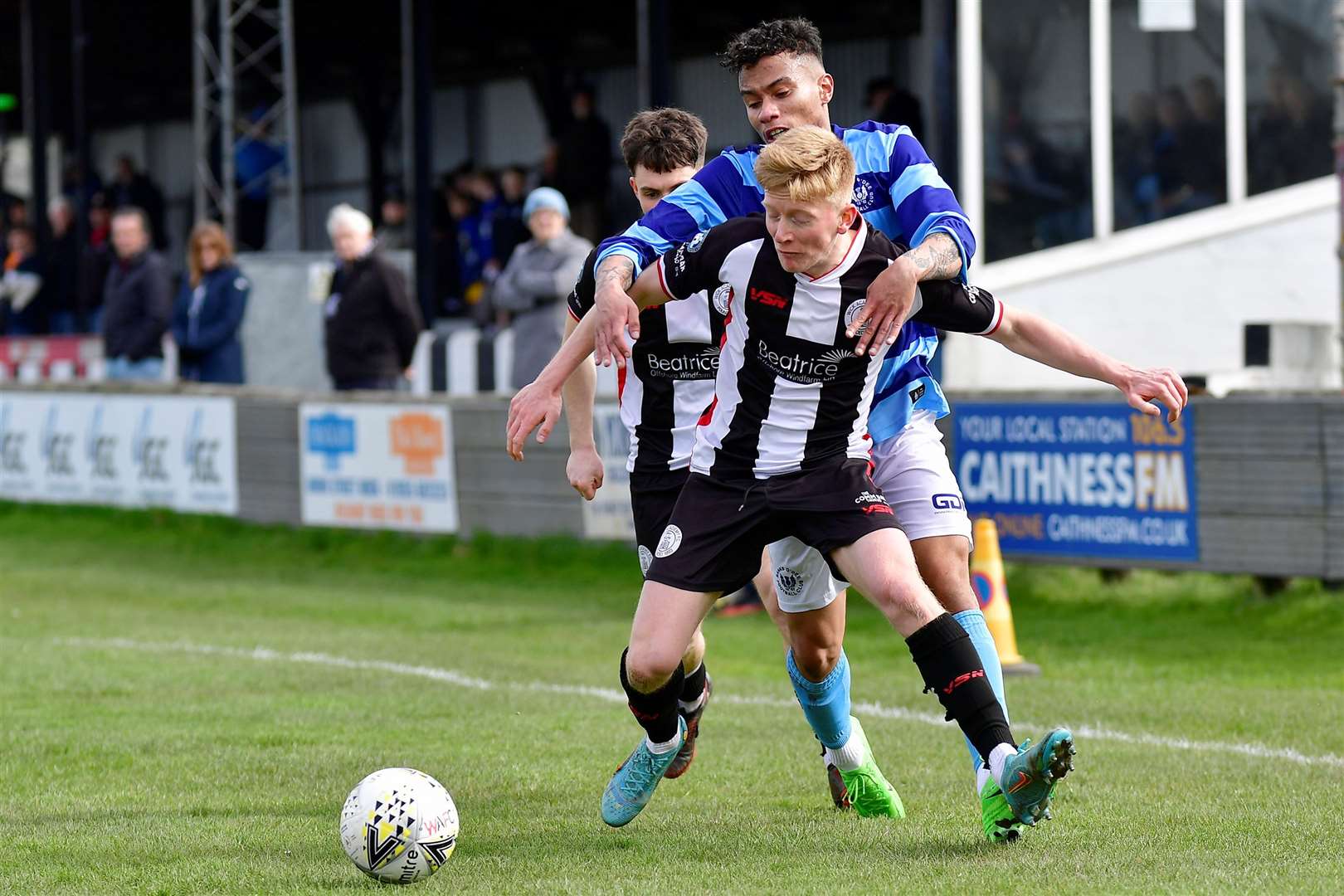 Wick Academy's Ross Gunn is held back by Banks O' Dee opponent Luke Emmett. Picture: Mel Roger