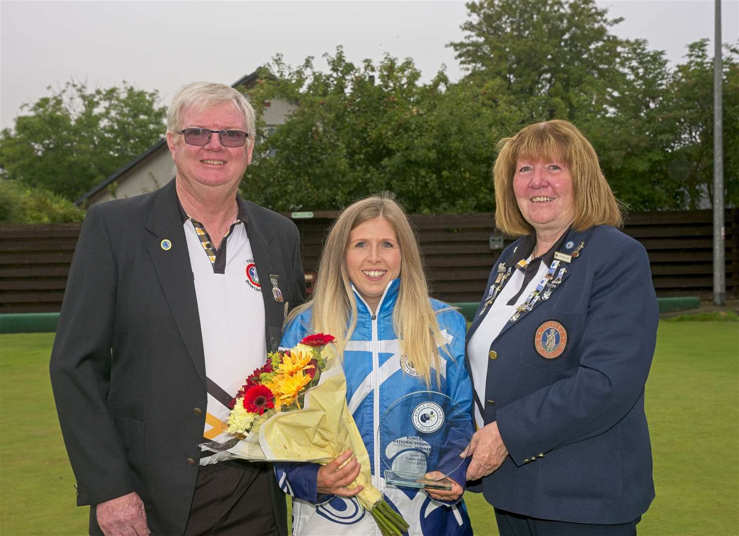 Lynne Swanson receiving her National Volunteer Award from Janet Sinclair, secretary of Thurso Bowling Club, with club president Douglas Morrison looking on. Picture: Billy Husband