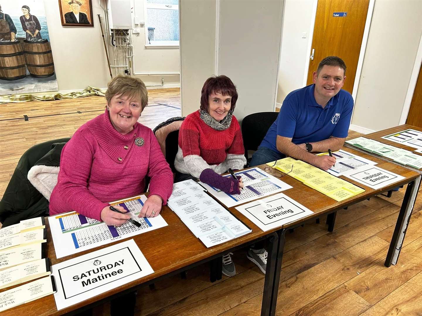Jenny Szyfelbain (left), Alison Munro and Allan Bruce selling tickets for the panto.
