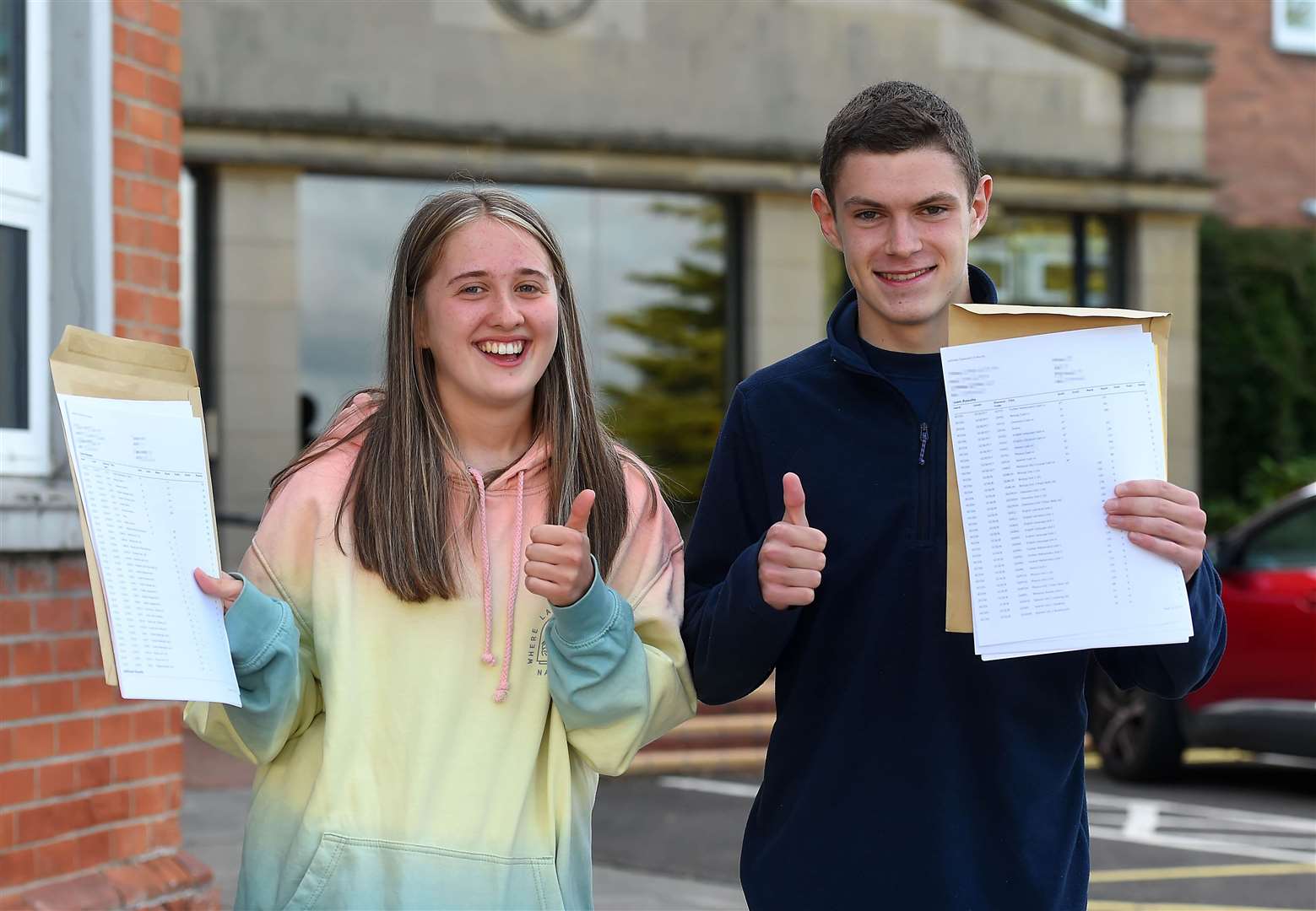 Grace McLaughlin and Jamie Morris celebrate their results at Sullivan Upper School (Oliver McVeigh/PA)