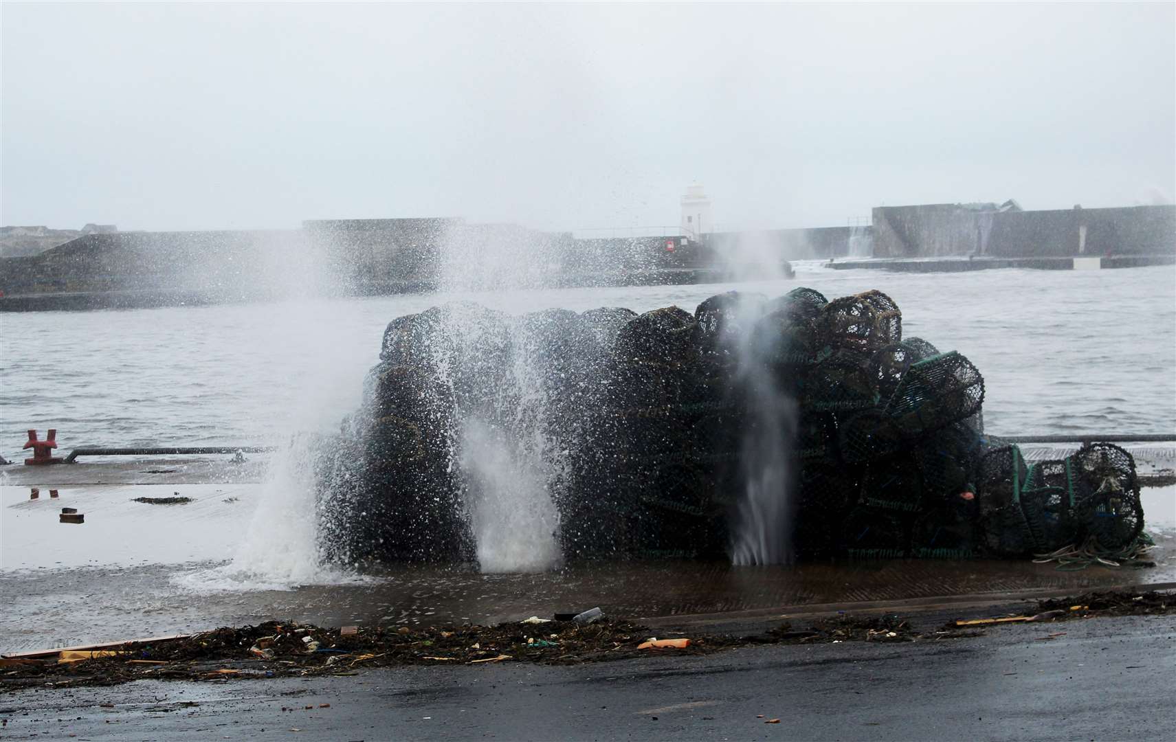 Around high tide, mini-fountains of seawater could be seen spouting up on the quayside at Wick's outer harbour. Picture: Alan Hendry