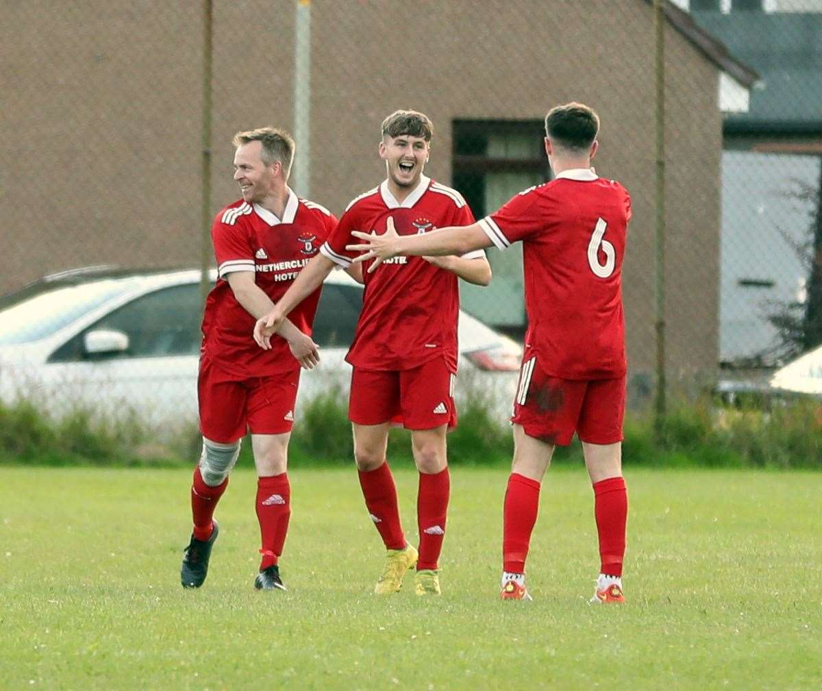 Brandon Sinclair (centre) takes the acclaim after scoring Wick Groats' fifth goal. Picture: James Gunn