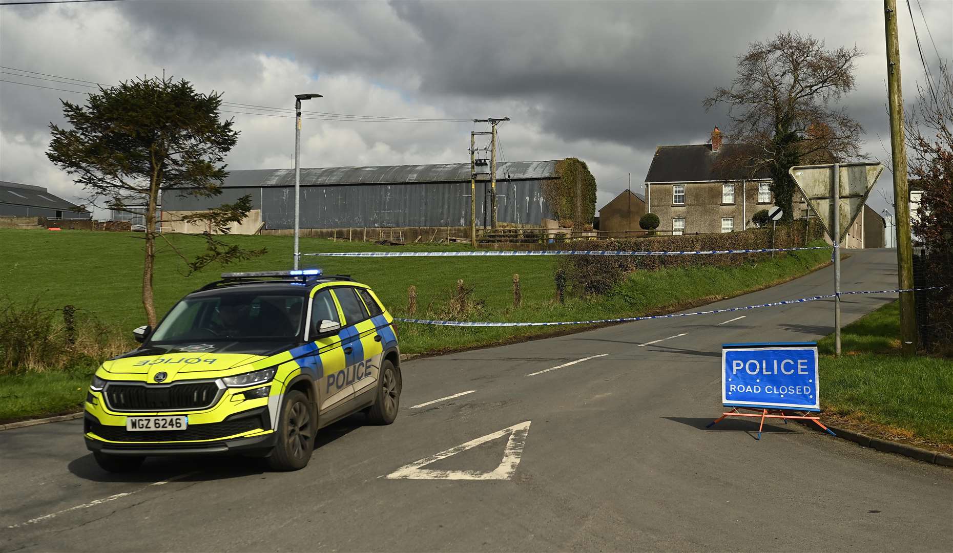 A police cordon remains at Ballynahonemore Road (Oliver McVeigh/PA)