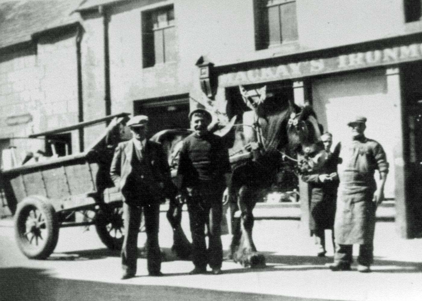 Thurso’s binmen James 'Teaser' Sutherland (second left) and John 'Geegor' McGregor (right) outside Mackays Ironmongers, High Street.