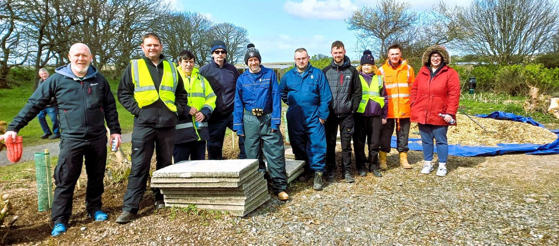 Allan (2nd from left) with Wick Paths Group volunteers and Rolls Royce workers helped clear up pathways around Wick riverside this year.