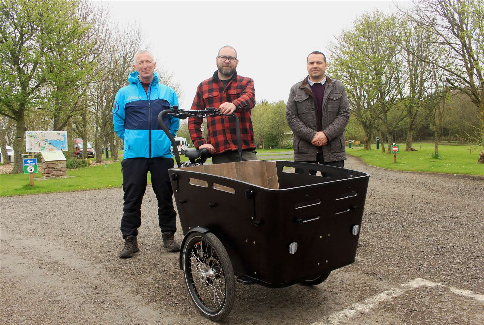 George Ewing (left), Cycling UK development officer for Caithness, delivering the cargo ebike to Martin Kelly (centre), warden supervisor at Wick River Campsite, and Jonathan Miller, chairman of Wick Development Trust. Picture: Alan Hendry
