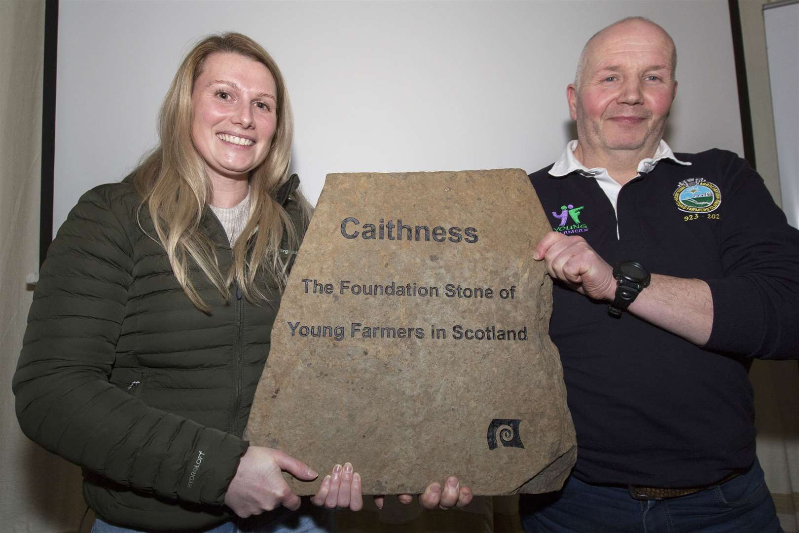 Sandy Douglas, chairman of the Caithness Young Farmers' 100th anniversary committee, hands over an engraved stone to Fiona Swanson, the Scottish Association of Young Farmers Clubs' North Area development officer. The stone came from Sandy's farm at Achnamoine and was then engraved and displayed at the various events during the centenary year. It will be embedded in a wall when the organisation's new headquarters are built at Ingliston, Edinburgh. Picture: Robert MacDonald / Northern Studios