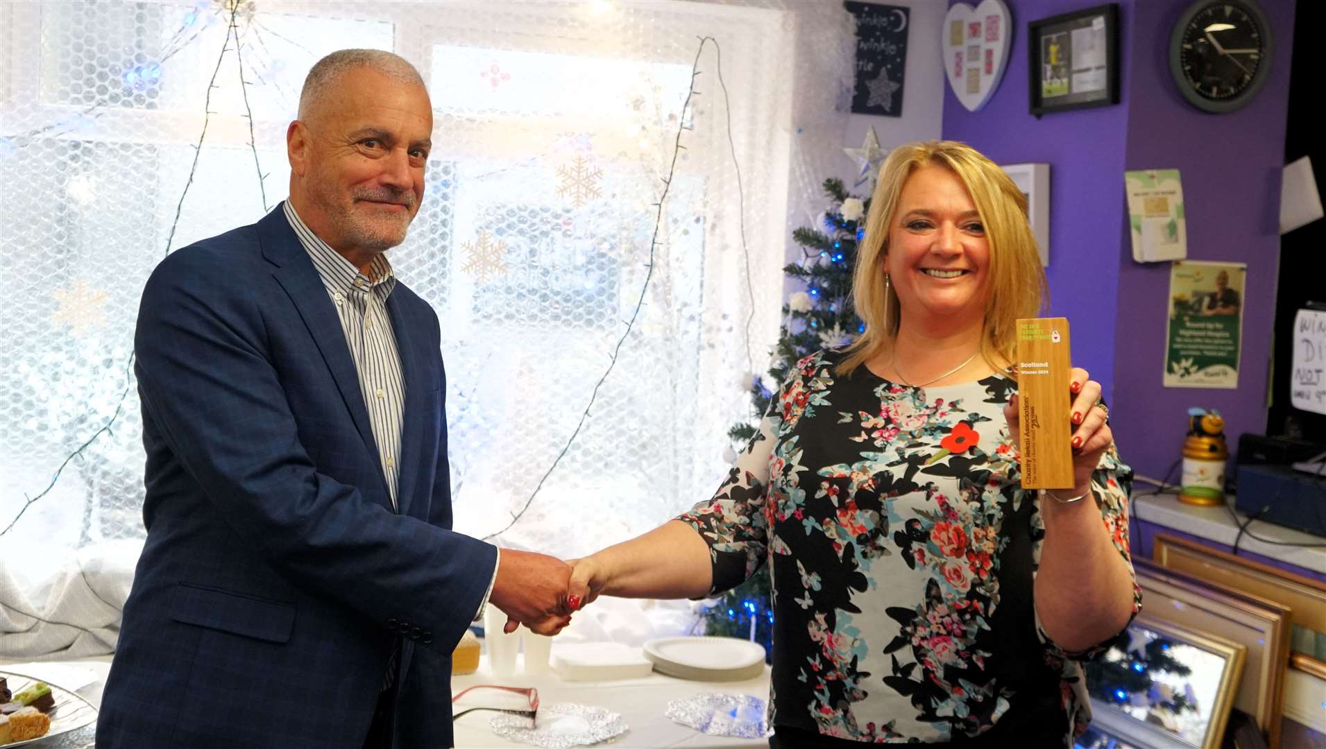 Robin Osterley, CEO of the Charity Retail Association, presents the award to Susan Imlach, manager of Highland Hospice's Thurso branch. Picture: DGS