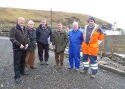 Highland Council harbourmaster Tony Usher (third left), with Landward Caithness councillor Willie Mackay (left), talks to Friendly Society of Lybster Harbour members – (from second left) Dave Scadding, Iain Gunn, George Carter and secretary Jay Mackay.