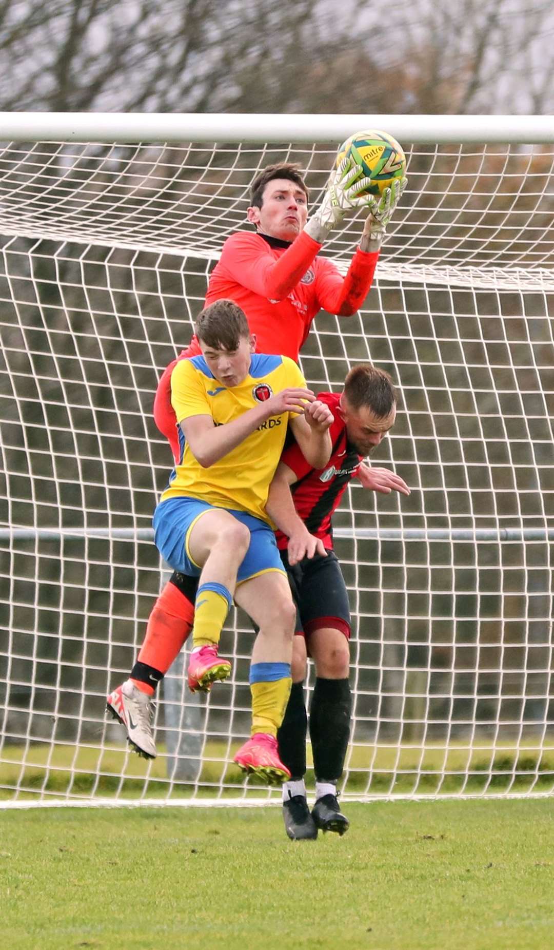 Halkirk United keeper Kieran Macleod makes a save under pressure from Orkney's Max Linklater. Picture: James Gunn