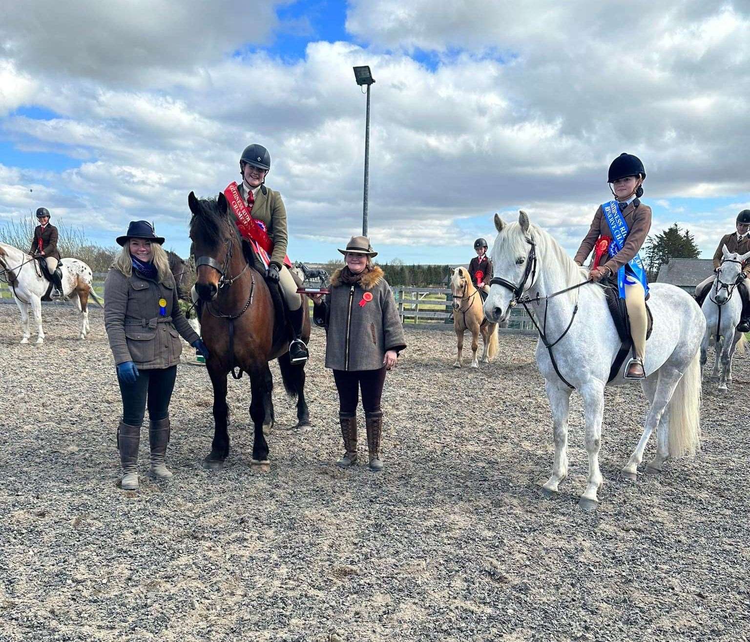 Morven Mackenzie and Llynhelyg Lady Cilla receive the working hunter pony championship sash from judges Lara and Kirstin Hourie, with Balladen Macmagum, ridden by Ava Bain, reserve.