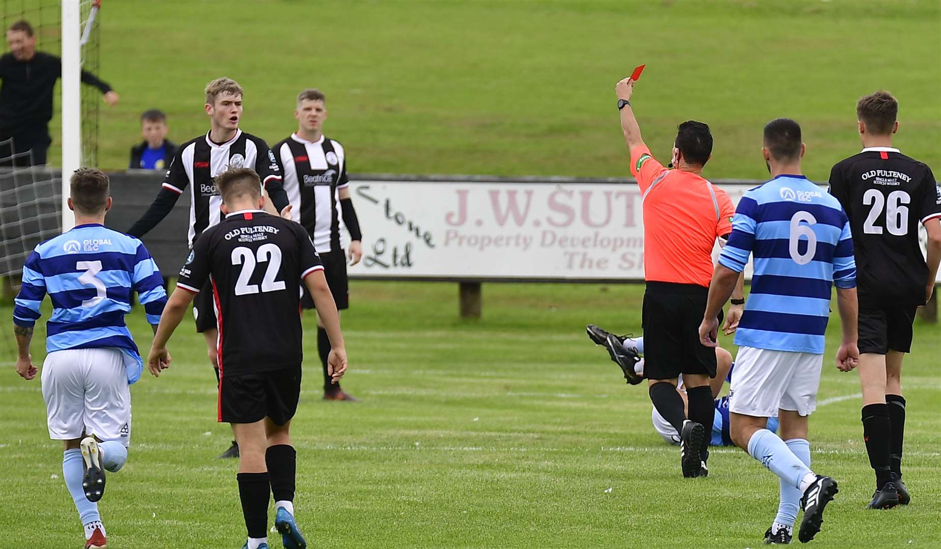 Referee Billy Baxter brandishes red card at Wick Academy defender Joe Anderson. Picture: Mel Roger