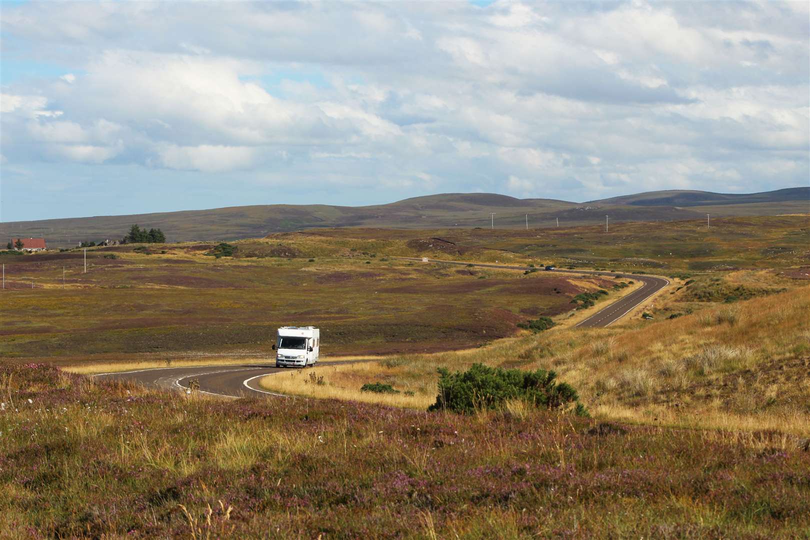 A campervan on a Highland road.