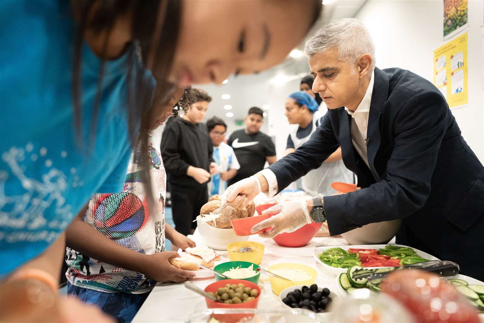 Mayor of London Sadiq Khan meets young people benefitting from free holiday meals (Stefan Rousseau/PA)