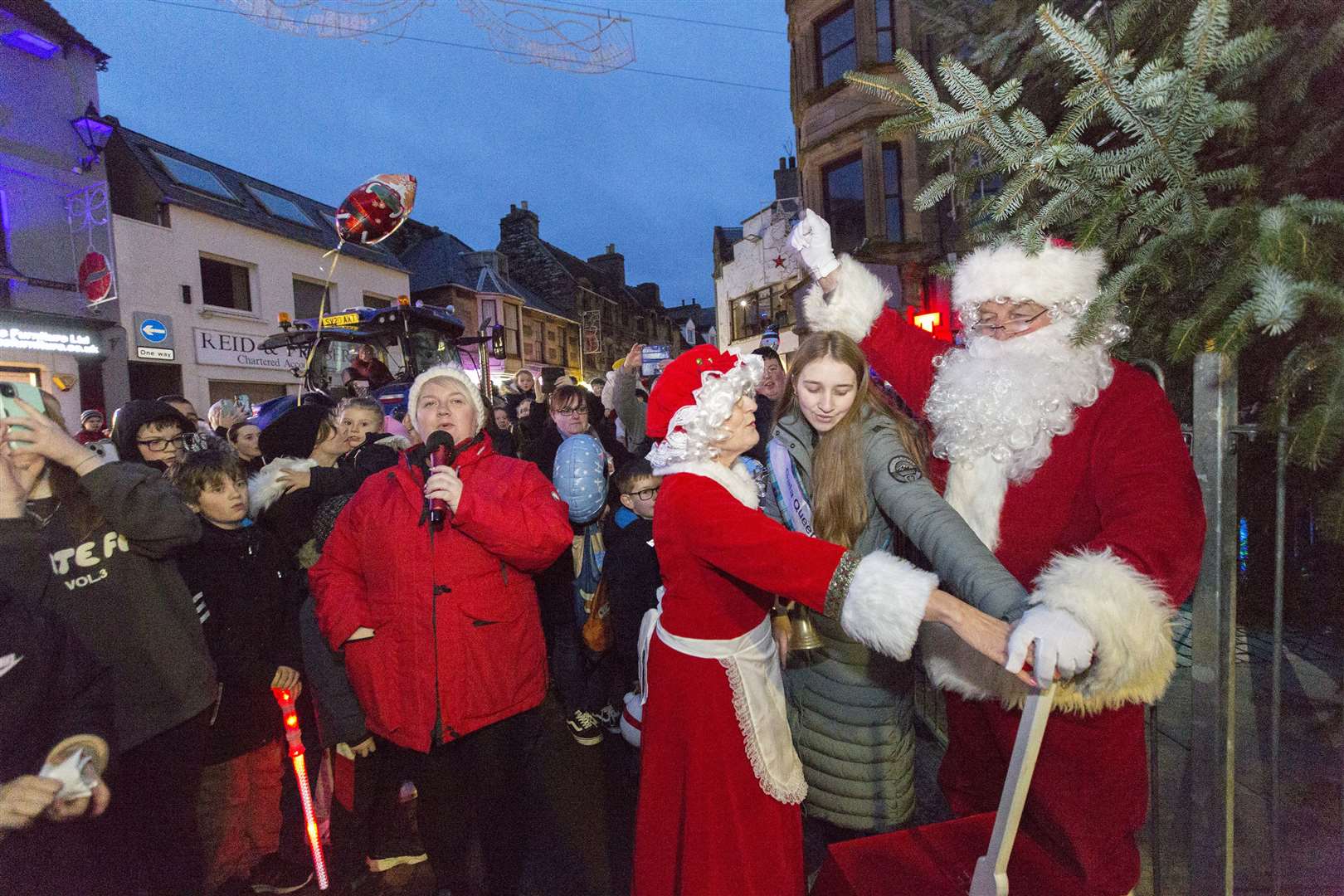 Wick Christmas Lights Committee chairperson Claire Mackenzie counts down to the switch-on as gala queen Abby Dunbar, assisted by Santa and Mrs Claus, prepares to light up the town centre. Picture: Robert MacDonald / Northern Studios