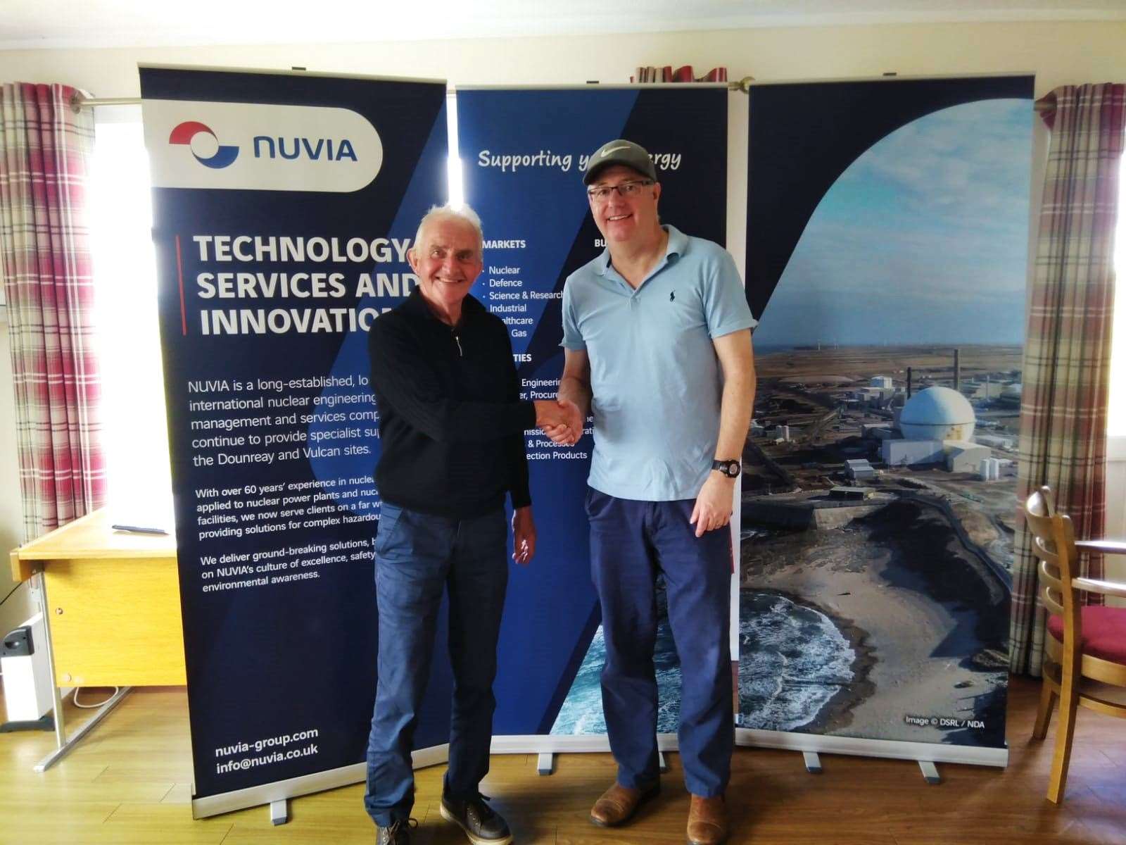 Fred Groves (left) being congratulated by David Craig (Nuvia portfolio manager) after his win in the Donald Campbell Open sponsored by Nuvia.