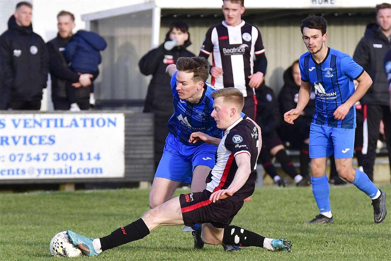 Ross Gunn of Wick Academy gets to the ball ahead of Strathspey Thistle's Daniel Whitehorn. Picture: Mel Roger
