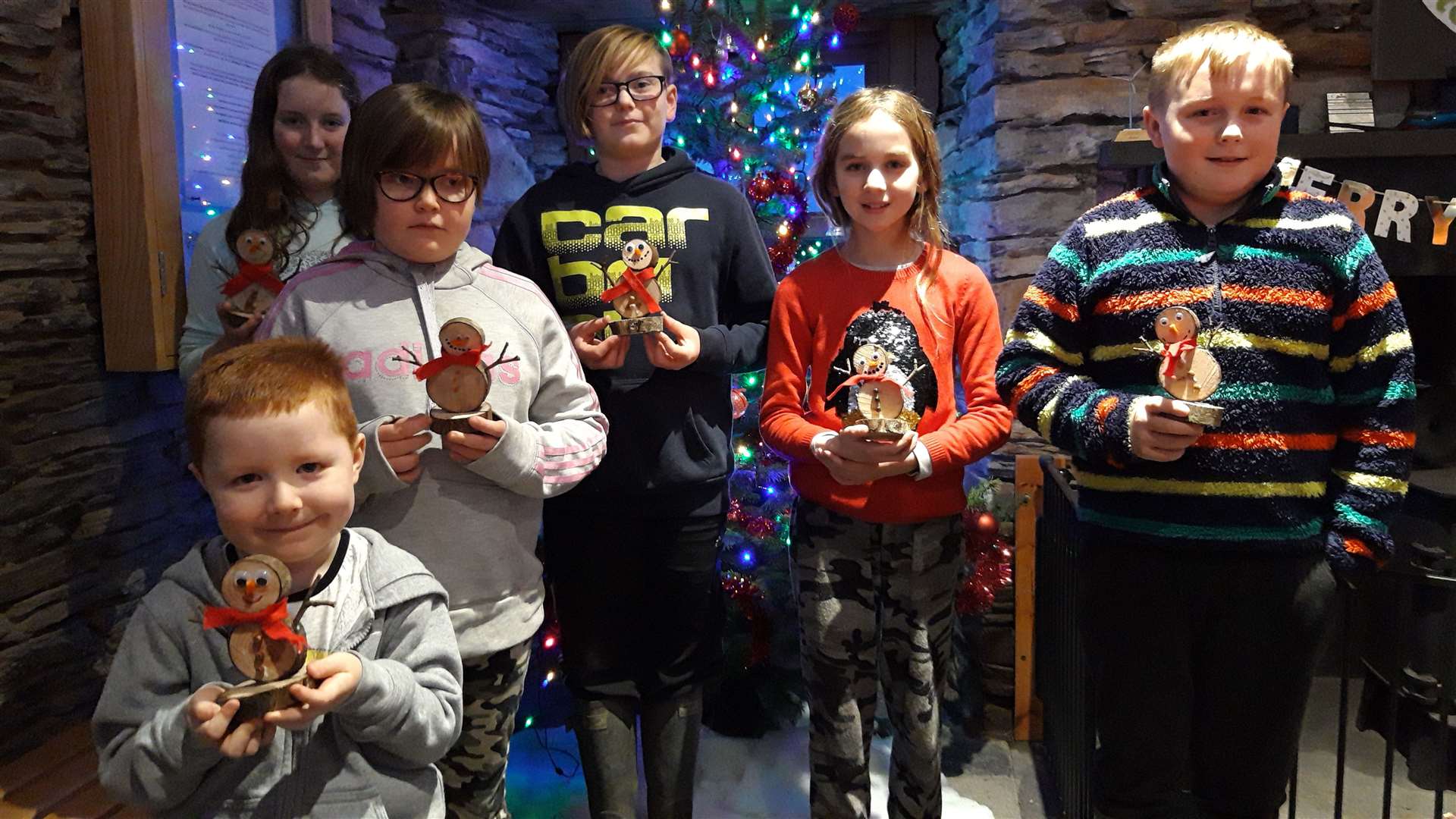 Youngsters who created wooden snowmen in the croft cottage.