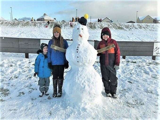 Is this Ivan the Terrible come to visit Wick in person perhaps? These children were delighted to make a snowman that towers over them at Harmsworth Park yesterday. From left, Danny Gow, Hallie Bremner and Dylan Gow. Mum of the two boys, Paula Davidson, said it was just what the kids needed in this 'tough time'. Picture: Paula Davidson