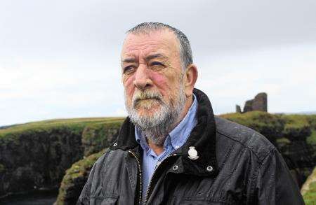 Ian Cassells with the Norse-era Castle of Old Wick in the background.