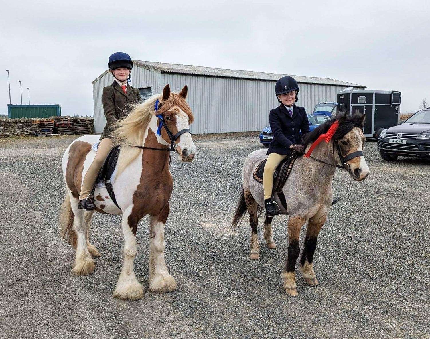 Caysie Sinclair and Zara (left), winners of the junior Into C test, along with Rachel MacGregor and Dandy, who won the Intro A junior section.