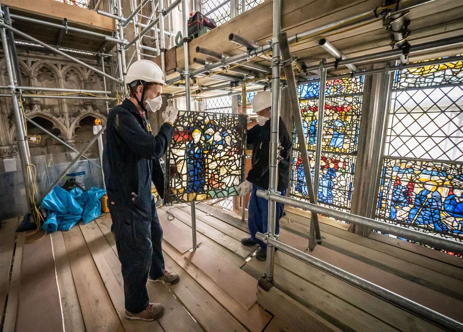 Conservator Matthew Nickels (left) and Master Glazier Tony Cattle, from York Glaziers Trust, removed a stained glass panel from York Minster’s St Cuthbert Window (Danny Lawson/PA)