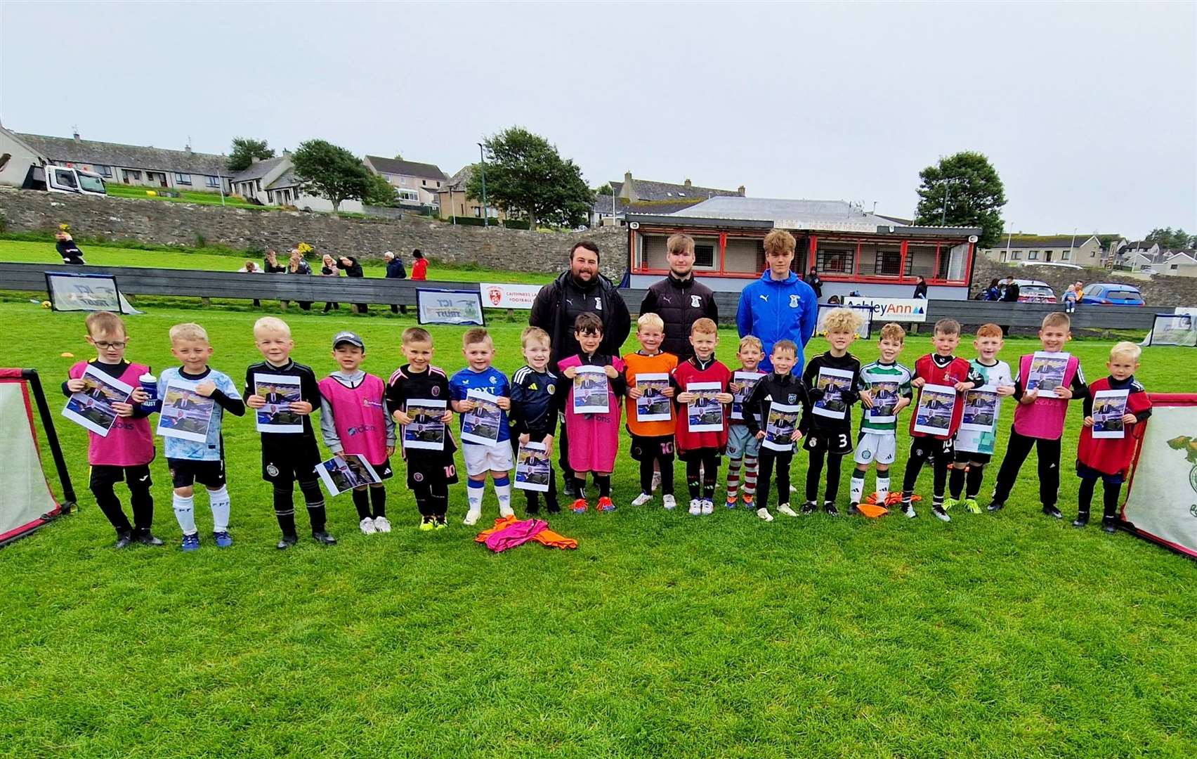 Coaches Lewis Maclean and Craig Shand, alongside Caley Thistle academy player Sam Reid, with the younger age group.