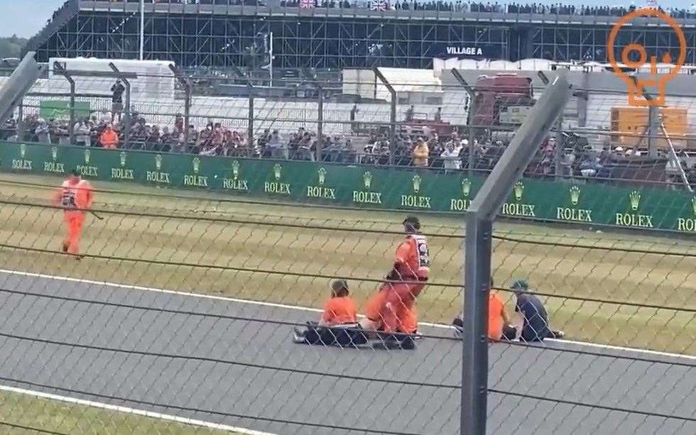 Protesters were dragged off the circuit after entering the track at the 2022 British Grand Prix (Northamptonshire Police/PA)