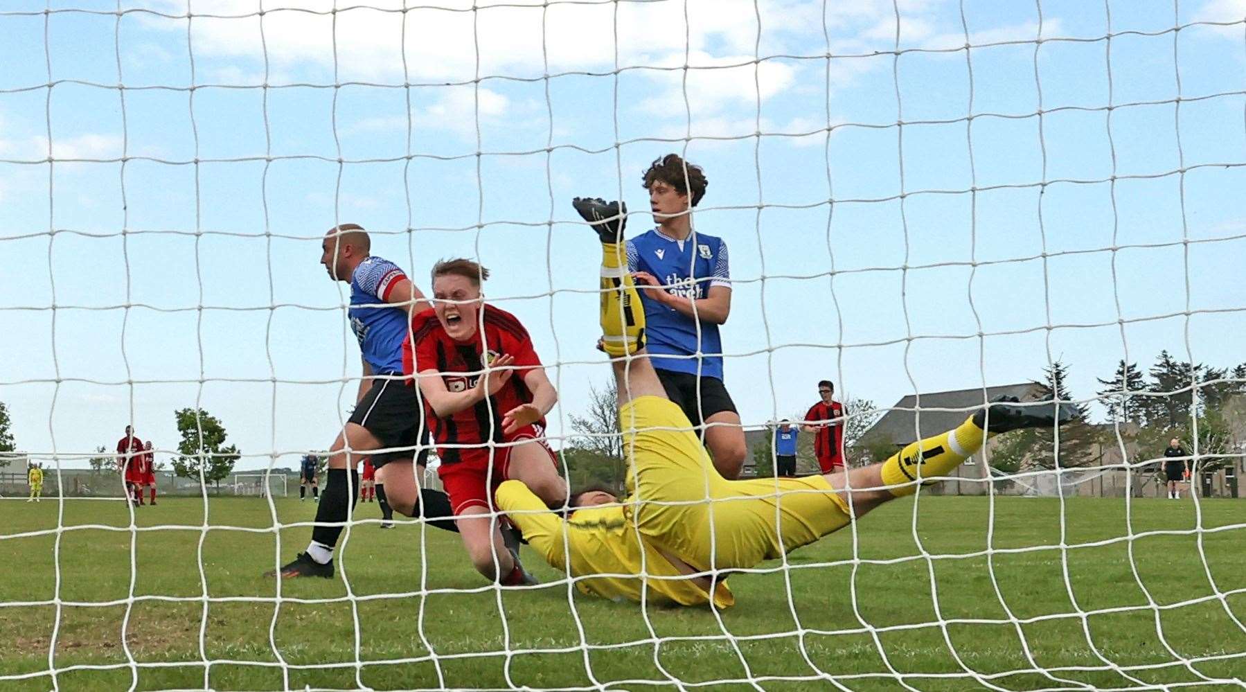 Halkirk's Ally Mackintosh crashes to the ground after being fouled by Lochbroom's Seumas Charity and earning a penalty. Picture: James Gunn