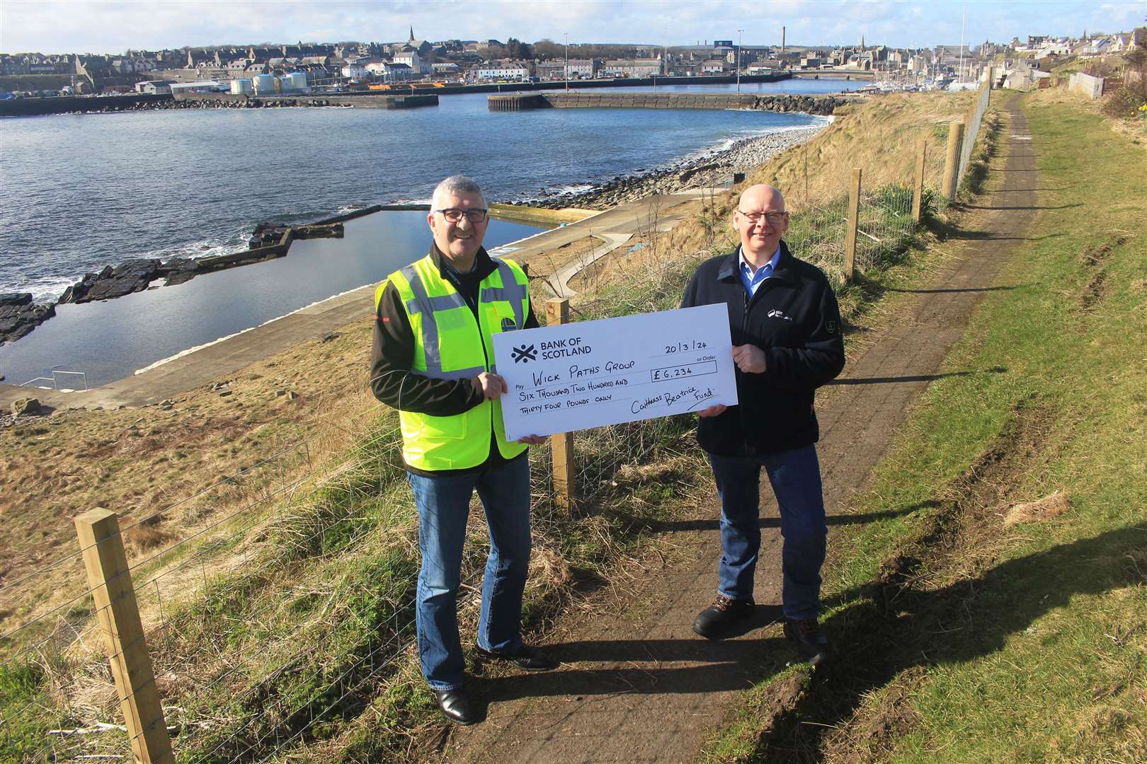 Willie Watt (left), chairman of Wick Paths Group, accepting the Caithness Beatrice Community Fund cheque from David Shearer, SSE Renewables community investment manager. Picture: Alan Hendry
