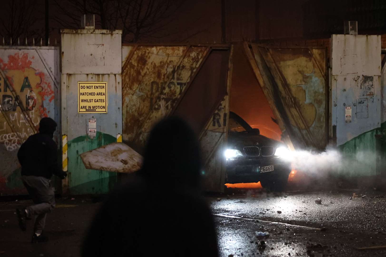 A car bursts through the Peace Gates in Lanark Way on Wednesday night (Liam McBurney/PA)