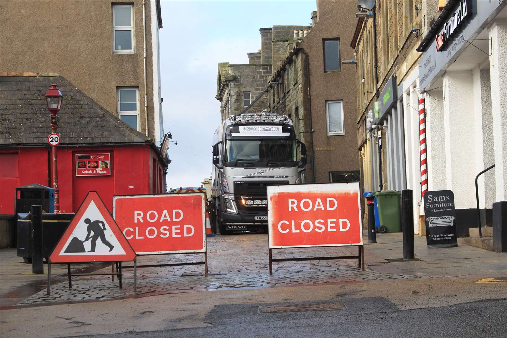 Part of Wick's High Street is cut off while workmen try to fix the problem.