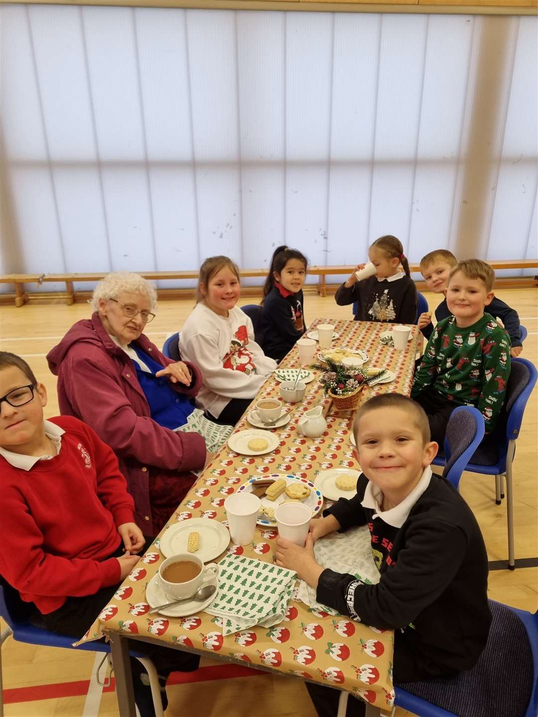 Guests and pupils enjoying afternoon tea together.