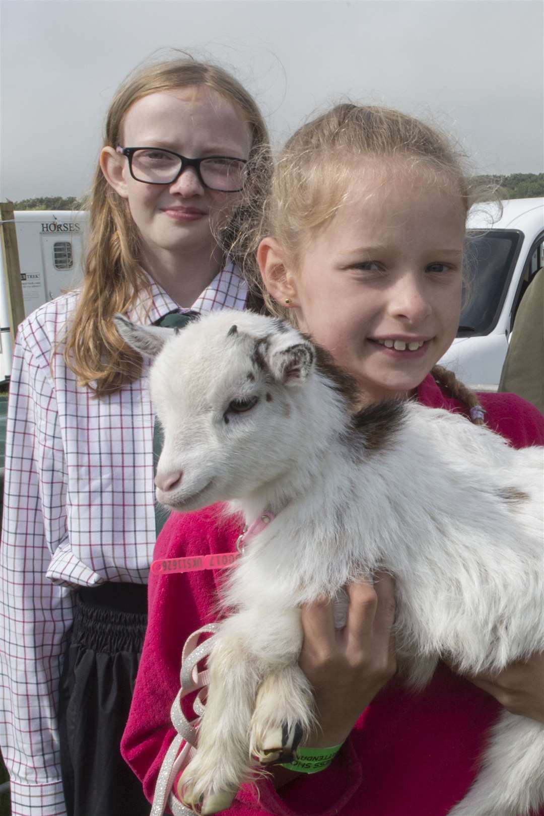 Not a champion but one of cutest animals on the showground was Little Minx – a 10-week-old goat kid owned by Robbianne Harrold, Ambervale, Reiss. Here she is with Sophie Sutherland, with Freya Innes in the background. Picture: Robert MacDonald / Northern Studios