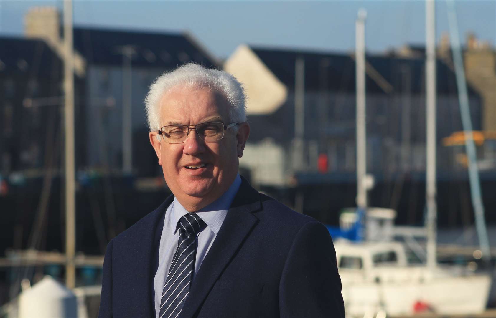 Wick harbour master Malcolm Bremner, with part of the Beatrice operations and maintenance base in the background. He says there is a bright future for Caithness, and in particular Wick harbour. Picture: Alan Hendry