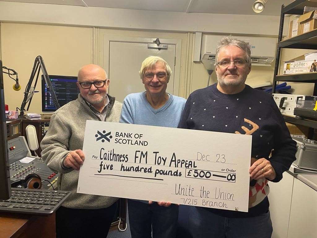 The cheque is handed over to Brian by Davie and John