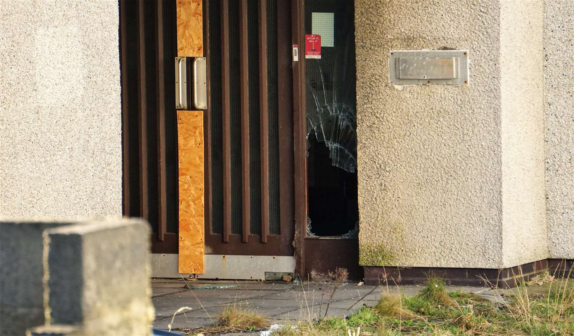 Glass panel of door is smashed in. Picture: DGS