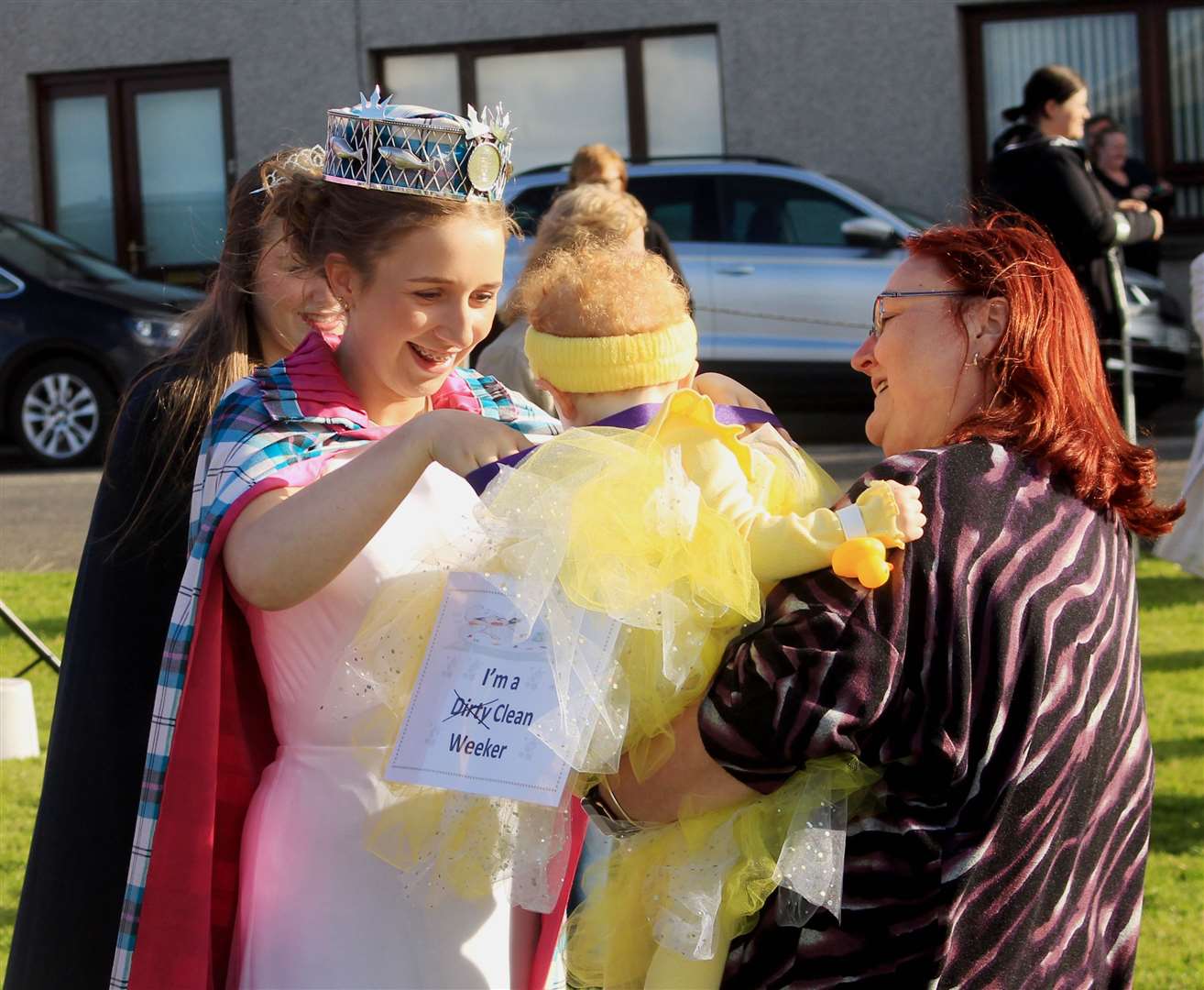 Gala queen Abby Dunbar presents a medal to a 'Clean Weeker' at the fancy dress parade. Picture: Alan Hendry